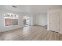 Bright living room featuring wood-look floors, fresh white paint, and recessed lighting at , Las Vegas, NV 89118