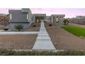 Stunning modern home with landscaped front yard and walkway at 1455 Macdonald Ranch Dr, Henderson, NV 89012