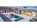 Modern backyard oasis with sleek pool and outdoor lounge area at 1455 Macdonald Ranch Dr, Henderson, NV 89012