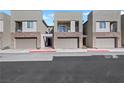Contemporary townhouse exteriors feature a mix of stone veneer and private balconies at 234 Walsh Peak Ave, Henderson, NV 89015
