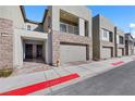 Contemporary townhome exteriors with stone accents, private balconies, and brick-paved sidewalks at 234 Walsh Peak Ave, Henderson, NV 89015