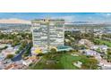 Expansive aerial view of the tower, showcasing its community pool, tennis court, golf course, and gardens at 3111 Bel Air Dr # 15D, Las Vegas, NV 89109