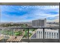 A spacious balcony view boasts outdoor seating, a lush golf course, a pond and cityscape, with mountains in the distance at 322 Karen Ave # 2206, Las Vegas, NV 89109