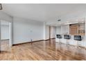 An open-concept living room features hardwood floors and a modern kitchen with bar stool seating at 322 Karen Ave # 2206, Las Vegas, NV 89109