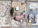 Aerial view showcasing two homes with spacious properties, multiple outbuildings, and serene desert surroundings at 3581 Ranger Way, Pahrump, NV 89048