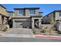 Charming two-story home with a paved driveway, attached garage, and inviting front entrance at 394 Red Feather Peak Ct, Las Vegas, NV 89138