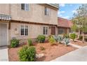 Close-up of a townhome exterior showcasing desert landscaping, a walkway, and a welcoming front entrance at 3986 Visby Ln, Las Vegas, NV 89119