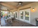 Covered patio with comfortable seating, ceiling fans, and neutral colors, ideal for outdoor relaxation at 4014 Trapani Pl, Las Vegas, NV 89141