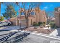 Charming townhome featuring a two-car garage and tidy desert landscaping at 5305 La Patera Ln, Las Vegas, NV 89149