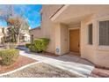Inviting front entrance with a secure ADT system and desert landscaping at 5305 La Patera Ln, Las Vegas, NV 89149