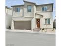Modern two-story home featuring an attached garage, brick steps, and fresh landscaping at 6840 Sunflower Fields St, North Las Vegas, NV 89086
