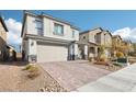 Beautiful two-story home with brick driveway, desert landscaping, and attached two car garage at 6844 Bayou Hollow Ave, Las Vegas, NV 89156