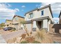 Attractive two-story house featuring a brick driveway, desert landscaping, and attached two-car garage at 6844 Bayou Hollow Ave, Las Vegas, NV 89156