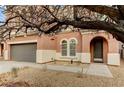 Charming home featuring desert landscaping, a covered porch, and an attached two-car garage at 7158 Clear Range Ave, Las Vegas, NV 89178