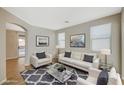 Bright living room with a cozy seating arrangement and a modern rug at 7158 Clear Range Ave, Las Vegas, NV 89178