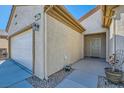 A cozy front entryway featuring a neutral color palette and access to the attached two-car garage at 7461 Crested Quail St, North Las Vegas, NV 89084