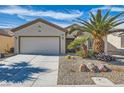 Inviting single-story home featuring a well-kept front yard and a convenient two-car garage at 7461 Crested Quail St, North Las Vegas, NV 89084