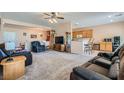 Spacious living area with neutral tones, comfortable seating, and an open layout to the kitchen at 7461 Crested Quail St, North Las Vegas, NV 89084