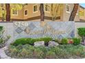 Elegant community entrance sign with lush landscaping and golden lettering at 5250 S Rainbow Blvd # 1165, Las Vegas, NV 89118