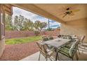 Relaxing backyard with covered patio area, lush lawn, and well-maintained landscaping at 1009 Rustridge Ave, North Las Vegas, NV 89081