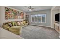 Cozy living room with large windows providing natural light and a comfortable seating area at 1009 Rustridge Ave, North Las Vegas, NV 89081