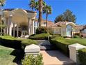 Stunning home featuring a grand entrance, beautiful landscaping, and well-manicured lawn at 12 Innisbrook Ave, Las Vegas, NV 89113