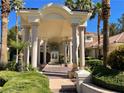 Majestic home with a grand, columned entrance and meticulously maintained landscaping at 12 Innisbrook Ave, Las Vegas, NV 89113