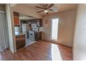 Cozy kitchen featuring wood cabinets, white appliances, and an adjacent dining area at 1405 E Vegas Valley Dr # 112, Las Vegas, NV 89169