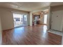 Inviting living area with hardwood flooring, adjacent to an open kitchen and a bright, sunlit balcony at 1405 E Vegas Valley Dr # 112, Las Vegas, NV 89169