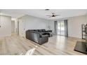 Spacious living room with hardwood floors, modern ceiling fan, and sliding glass doors at 1500 Saylor Way, Las Vegas, NV 89108