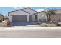 Lovely single-story home with desert landscaping, a paved driveway, and a two-car garage at 2255 Woodbluff Ave, North Las Vegas, NV 89086