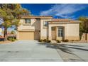 Charming two-story home featuring a well-manicured front yard, tile roof, and a two-car garage at 2345 Cliffwood Dr, Henderson, NV 89074