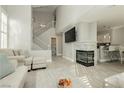 Bright and airy living room with fireplace, stairs and hard flooring at 2345 Cliffwood Dr, Henderson, NV 89074