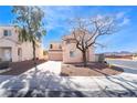 Two-story home features a tile roof, attached garage, and low-maintenance landscaping at 2407 Belt Buckley Dr, Henderson, NV 89002
