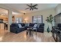 Inviting living room with hardwood floors, large sectional sofa, and a bright, open layout at 2724 Rosarito St, Las Vegas, NV 89108