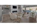 Bright living room with a cozy fireplace, recessed lighting, and backyard pool view at 3998 Montone Ave, Las Vegas, NV 89141