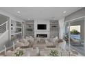 Stylish living room featuring a modern fireplace, built-in shelving, and backyard access at 3998 Montone Ave, Las Vegas, NV 89141