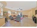 Spacious living room with tile flooring, ceiling fan, and a sliding glass door at 4217 Gliding Gulls Ave, North Las Vegas, NV 89084