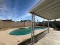 Backyard pool features a covered patio and concrete deck, perfect for outdoor entertaining at 5194 Saratoga Dr, Las Vegas, NV 89120