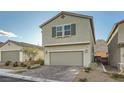 Inviting two-story home featuring a two-car garage and a paver driveway at 5399 El Nevero St, Las Vegas, NV 89166