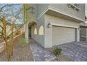 Attractive two-story home featuring a two-car garage and inviting walkway to front door at 5399 El Nevero St, Las Vegas, NV 89166