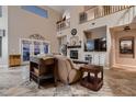Spacious living room with a fireplace, neutral decor, and large windows, offering comfortable seating and natural light at 5416 Irish Spring St, Las Vegas, NV 89149