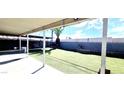 Spacious backyard featuring a covered patio, artificial grass, and a palm tree accent at 5617 Tanya Ave, Las Vegas, NV 89107