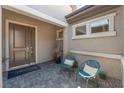 Inviting front porch with stylish seating and a decorative welcome mat at 6312 Zephyr Peak Ct, Las Vegas, NV 89149