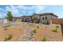 Beautiful single-story home showcasing desert landscaping, including stone accents and drought-resistant plants at 6312 Zephyr Peak Ct, Las Vegas, NV 89149