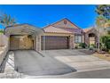 Charming single-story home showcasing a well-maintained front yard with a covered parking structure and a two-car garage at 6587 Lucky Boy Dr, Las Vegas, NV 89110