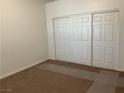 A cozy bedroom featuring a spacious closet with white sliding doors, offering ample storage space at 75 N Valle Verde Dr # 621, Henderson, NV 89074