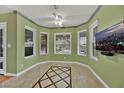 Bright dining room featuring a bay window, tiled floor, ceiling fan, and a wall-mounted TV at 7713 Shore Haven Dr, Las Vegas, NV 89128