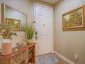 Inviting entryway featuring a console table with a mirror, artwork, and tile flooring at 9211 Wittig Ave, Las Vegas, NV 89149