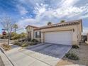 Exterior view of a single-story home with a two-car garage, low maintenance landscaping and a tile roof at 9211 Wittig Ave, Las Vegas, NV 89149